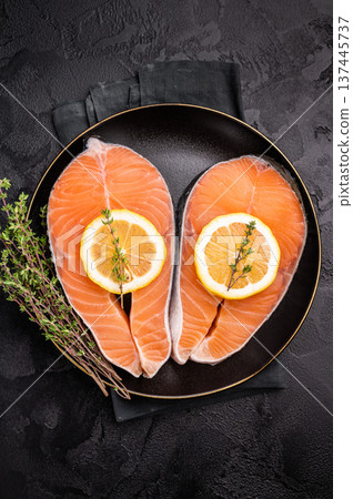High-quality salmon portion, ready to be transformed into a gourmet dish. A versatile ingredient for both traditional and modern recipes. black background. top view High-quality salmon portion, ready to be transformed into a gourmet dish. A versatile ingredient for both traditional and modern recipes. black background. top view 137445737