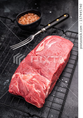 Close-up of raw horse meat, emphasizing its quality and freshness, ready to be transformed into exquisite dishes for adventurous palates. black background. top view Close-up of raw horse meat, emphasizing its quality and freshness, ready to be transformed into exquisite dishes for adventurous palates. black background. top view 137445740