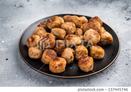 Savory meatballs, meat dumplings garnished with fresh herbs. A delightful addition to any meal, bringing warmth and satisfaction to the table. grey background. top view 137445746