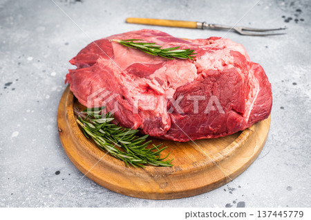 A selection of fresh beef shin, boneless shank meat cuts on a butcher block, emphasizing their quality and versatility for various cooking methods. greybackground. top view A selection of fresh beef shin, boneless shank meat cuts on a butcher block, emphasizing their quality and versatility for various cooking methods. greybackground. top view 137445779
