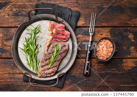 BBQ grilled Top Sirloin beef steak with herbs. wooden background. top view BBQ grilled Top Sirloin beef steak with herbs. wooden background. top view 137445790
