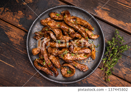 Traditional Asian beef teriyaki with herbs on a plate. wooden background. top view 137445802