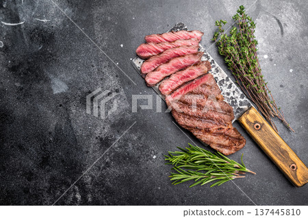 Savory shoulder steak Denver, beautifully cooked on the grill, highlighting its marbled texture and succulent taste. black background. top view Savory shoulder steak Denver, beautifully cooked on the grill, highlighting its marbled texture and succulent taste. black background. top view 137445810