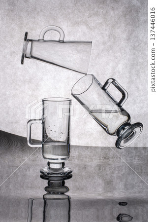Still life with glassware on a reflective surface 137446016