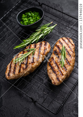 Grilled kofta kebabs made from spiced minced meat, perfectly grilled and served with fresh herbs and tangy sauce. black background. top view 137446019