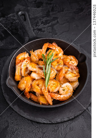 Close up of juicy grilled prawns garnished with herbs, a delicious seafood delight for any gourmet dish. black background. top view 137446028
