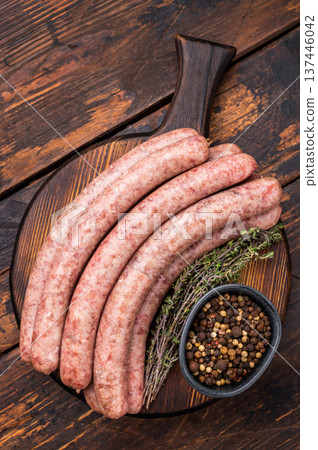 Uncooked sausage on a wooden board, a must have ingredient for delicious homemade recipes and comfort food. wooden background. top view Uncooked sausage on a wooden board, a must have ingredient for delicious homemade recipes and comfort food. wooden background. top view 137446042