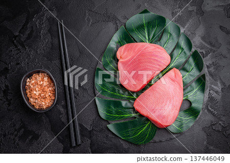 Beautifully cut raw tuna steak, rich in flavor and omega 3s, ready to elevate your culinary creations. black background. top view Beautifully cut raw tuna steak, rich in flavor and omega 3s, ready to elevate your culinary creations. black background. top view 137446049