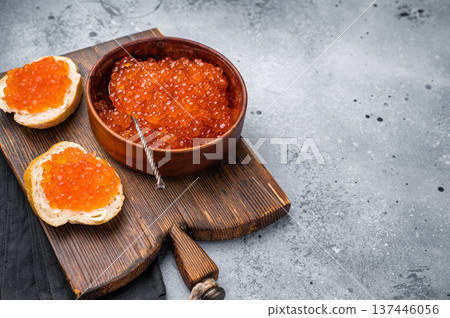 Salty salmon roe, red caviar, ideal for adding a touch of elegance to your culinary creations. grey ackground. top view Salty salmon roe, red caviar, ideal for adding a touch of elegance to your culinary creations. grey ackground. top view 137446056