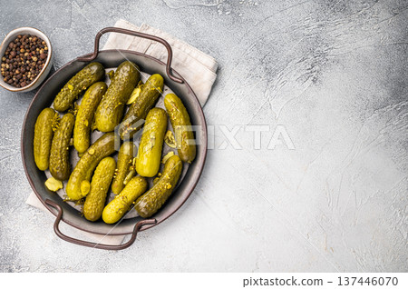 Freshly jarred dill pickles, a delightful addition to any meal or charcuterie board that adds a zesty crunch. grey background. top view Freshly jarred dill pickles, a delightful addition to any meal or charcuterie board that adds a zesty crunch. grey background. top view 137446070
