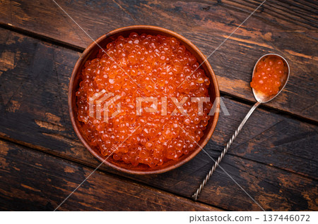 Delightful red caviar, a symbol of luxury and sophistication, ready to impress at your next gathering. wooden background. top view 137446072