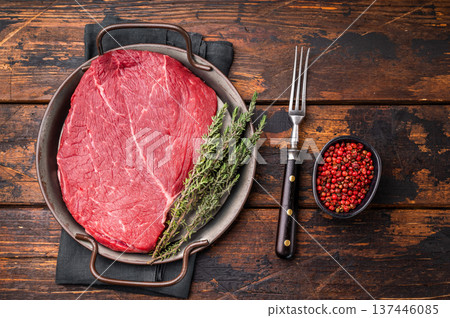 Premium raw rump or top sirloin beef steak on a tray, ready to be seasoned and grilled to perfection. wooden background. top view Premium raw rump or top sirloin beef steak on a tray, ready to be seasoned and grilled to perfection. wooden background. top view 137446085