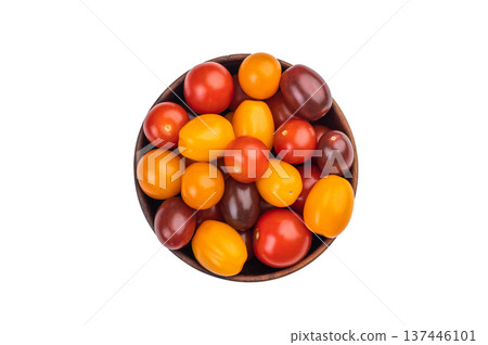 Colorful mix of heirloom cherry tomatoes in a wooden bowl shot overhead on white background, showcasing vibrant fresh produce.. Colorful mix of heirloom cherry tomatoes in a wooden bowl shot overhead on white background, showcasing vibrant fresh produce.. 137446101