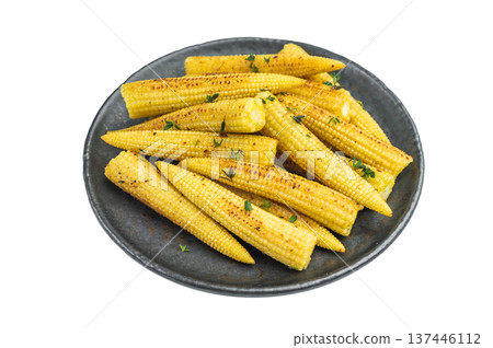 Golden roasted baby corn seasoned and garnished with thyme served in cast iron pan on white background ready cooked vegetable dish Golden roasted baby corn seasoned and garnished with thyme served in cast iron pan on white background ready cooked vegetable dish 137446112