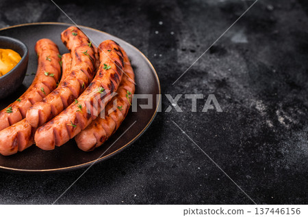 Gourmet grilled sausages (frankfurters/wieners) with mustard sauce and fresh thyme on a black plate. Ready-to-eat dinner. Gourmet grilled sausages (frankfurters/wieners) with mustard sauce and fresh thyme on a black plate. Ready-to-eat dinner. 137446156
