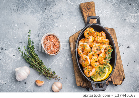 Ready-to-eat pan-seared shrimp (prawns) with fresh herbs, positioned for an advertisement or a clean, modern food magazine layout. Ready-to-eat pan-seared shrimp (prawns) with fresh herbs, positioned for an advertisement or a clean, modern food magazine layout. 137446162