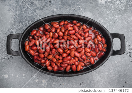 Kidney beans in a cast iron skillet on a rustic wooden board. Large gray copy space for text. Overhead, minimal style. 137446172