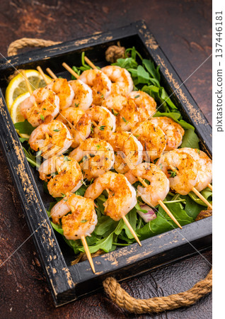 Grilled shrimp prawn skewers served in a rustic wooden box with thyme and a vintage fork. Dark, moody food photography with copy space. Grilled shrimp prawn skewers served in a rustic wooden box with thyme and a vintage fork. Dark, moody food photography with copy space. 137446181