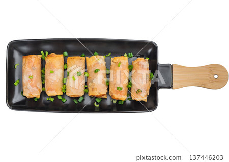 Crispy fried spring rolls Lumpia served on black ceramic plate with green onions Asian appetizer top view Crispy fried spring rolls Lumpia served on black ceramic plate with green onions Asian appetizer top view 137446203