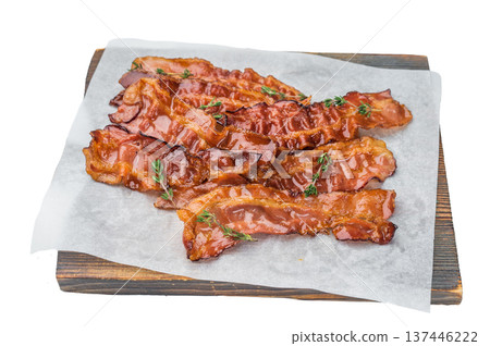 Golden crispy bacon rashers with rich sizzling pork glaze served on parchment with thyme perfect for culinary and menu designs. Golden crispy bacon rashers with rich sizzling pork glaze served on parchment with thyme perfect for culinary and menu designs. 137446222