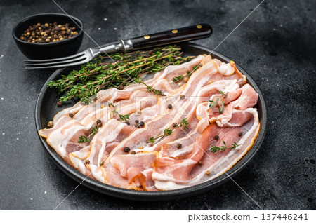Sliced marbled streaky bacon pork belly seasoned with thyme and pepper great for menus cooking blogs kitchen ads and stock food imagery Sliced marbled streaky bacon pork belly seasoned with thyme and pepper great for menus cooking blogs kitchen ads and stock food imagery 137446241