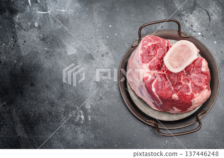 Raw veal shank hock whole piece with bone in cooking pan on stone background premium calf meat for braising and cuisine 137446248