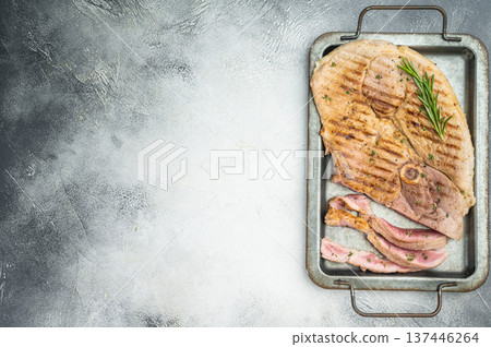 Barbecue pork shoulder joint with bone grilled and partially sliced on metal tray light background rustic food concept Barbecue pork shoulder joint with bone grilled and partially sliced on metal tray light background rustic food concept 137446264