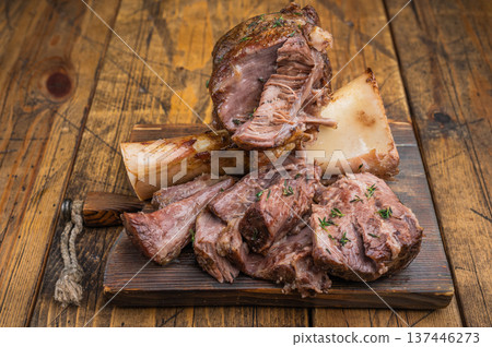 Slow cooked beef ossobuco shank with tender meat texture bone marrow wooden board flat lay 137446273