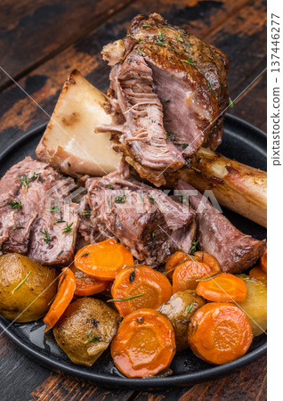 Classic italian veal shank osso buco plated with marrow bone and vegetables rustic food styling 137446277