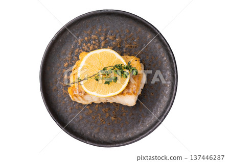 Roast Halibut fish loin fiilet on plate isolated on white background 137446287