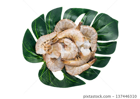 Raw headless white shrimps prawns isolated on white background. Raw headless white shrimps prawns isolated on white background. 137446310