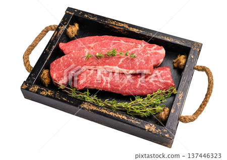 Raw skirt or machete Steak, beef meat in wooden tray with herbs isolated on white background Raw skirt or machete Steak, beef meat in wooden tray with herbs isolated on white background 137446323