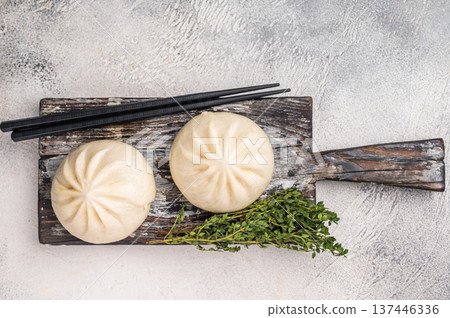 Traditional Dumpling Momos with meat on wooden board. white background. top view Traditional Dumpling Momos with meat on wooden board. white background. top view 137446336