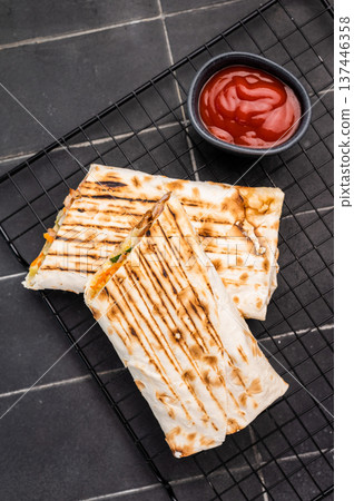 Turkish Shawarma, doner wrap sandwich with meat and salad. black background. top view Turkish Shawarma, doner wrap sandwich with meat and salad. black background. top view 137446358