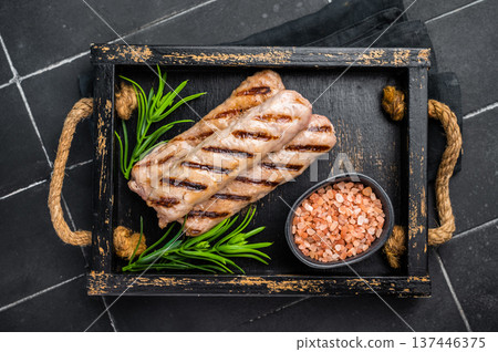 Roasted on BBQ beef and lamb sausages in wooden tray. black background. top view 137446375