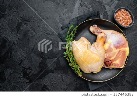 Chicken legs in a plate with herbs, farm poultry raw meat on black background, top view Chicken legs in a plate with herbs, farm poultry raw meat on black background, top view 137446392