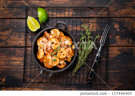 Roasted Shrimps Prawns with garlic and butter in a skillet. Wooden background. Top view 137446405