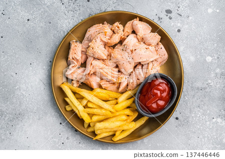 Dinner with Pulled salmon roast fillets and french fry on a plate. gray background. Top view Dinner with Pulled salmon roast fillets and french fry on a plate. gray background. Top view 137446446