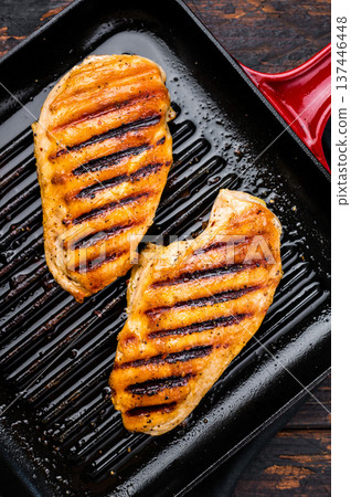 Roasted on grill pan Chicken breasts, fried poultry meat steaks, top view, wooden background. Roasted on grill pan Chicken breasts, fried poultry meat steaks, top view, wooden background. 137446448