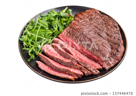 Juicy grilled top sirloin on a plate, accompanied by seasonal greens for a delicious meal. isolated on white background. top view Juicy grilled top sirloin on a plate, accompanied by seasonal greens for a delicious meal. isolated on white background. top view 137446478
