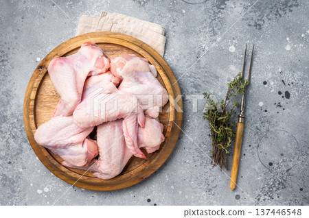 Fresh raw chicken wings, perfect for marinating and grilling, ready to become the star of your next barbecue. grey background. top view 137446548