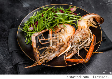 Elegant plate of grilled rosenbergii prawns shrimps garnished with fresh herbs, perfect for gourmet dining experiences. black background. top view Elegant plate of grilled rosenbergii prawns shrimps garnished with fresh herbs, perfect for gourmet dining experiences. black background. top view 137446549