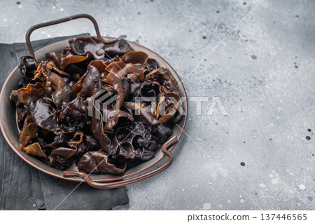 Fresh wood ear mushrooms, perfect for adding unique texture and flavor to your favorite Asian dishes. grey background. top view Fresh wood ear mushrooms, perfect for adding unique texture and flavor to your favorite Asian dishes. grey background. top view 137446565