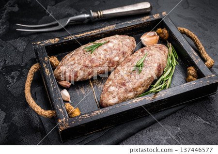 Raw kebabs or kabaps on wooden tray, beautifully arranged and ready to be cooked for a delicious outdoor feast. black background. top view Raw kebabs or kabaps on wooden tray, beautifully arranged and ready to be cooked for a delicious outdoor feast. black background. top view 137446577
