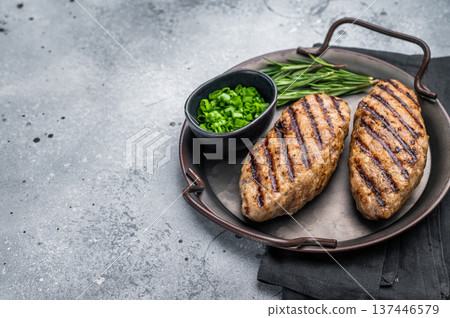 Close up of succulent grilled kofta kebabs or kebaps, showcasing rich spices and a tantalizing golden-brown crust. grey background. top view Close up of succulent grilled kofta kebabs or kebaps, showcasing rich spices and a tantalizing golden-brown crust. grey background. top view 137446579