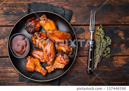 Deliciously sticky teriyakis sauce chicken wings, bursting with flavor, perfect for sharing at festive occasions or family dinners. wooden background. top view Deliciously sticky teriyakis sauce chicken wings, bursting with flavor, perfect for sharing at festive occasions or family dinners. wooden background. top view 137446590