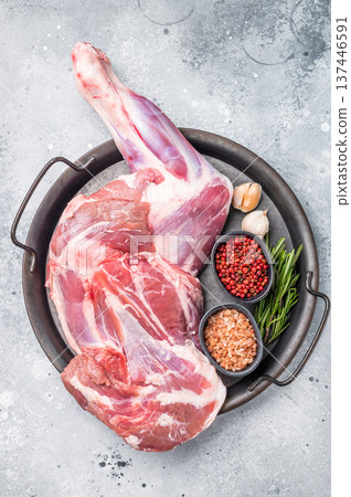 Whole fresh lamb mutton shoulder, inviting you to prepare a delicious roast that will impress your guests. white background. top view Whole fresh lamb mutton shoulder, inviting you to prepare a delicious roast that will impress your guests. white background. top view 137446591