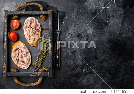 Gourmet style tuna sandwich with fresh herbs and spices, elevating your lunchtime experience to the next level. black background. top view Gourmet style tuna sandwich with fresh herbs and spices, elevating your lunchtime experience to the next level. black background. top view 137446594