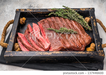 Close up of a perfectly grilled rump or top sirloin beef steak, highlighting its tenderness and flavorful crust, ideal for meat enthusiasts. white background. top view Close up of a perfectly grilled rump or top sirloin beef steak, highlighting its tenderness and flavorful crust, ideal for meat enthusiasts. white background. top view 137446600