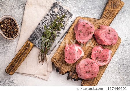 Juicy uncooked pork medallion, raw loin meat a versatile choice for stir fries or savory roasts in any cuisine. white background. top view Juicy uncooked pork medallion, raw loin meat a versatile choice for stir fries or savory roasts in any cuisine. white background. top view 137446601